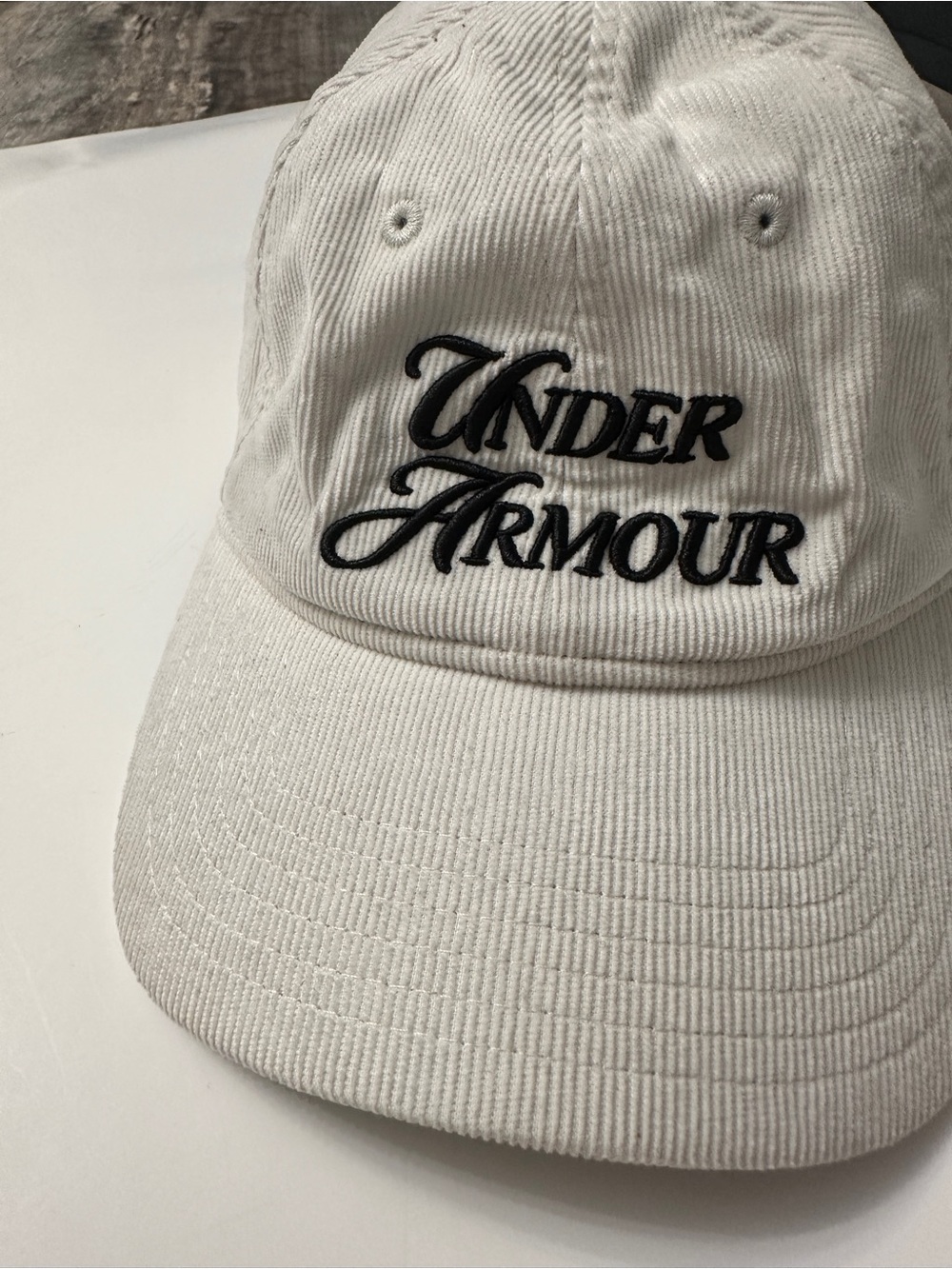 Under Armour Off-White Corduroy Cap with Black Script Logo adjustable strap back